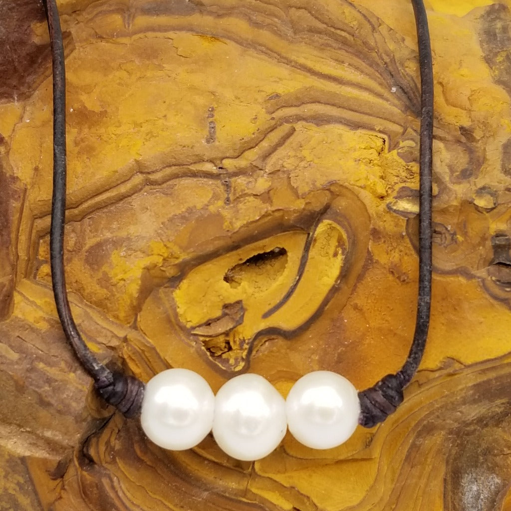 Three Freshwater Pearls on knotted leather with a sterling silver lobster claw clasp and a 1 in. extender chain