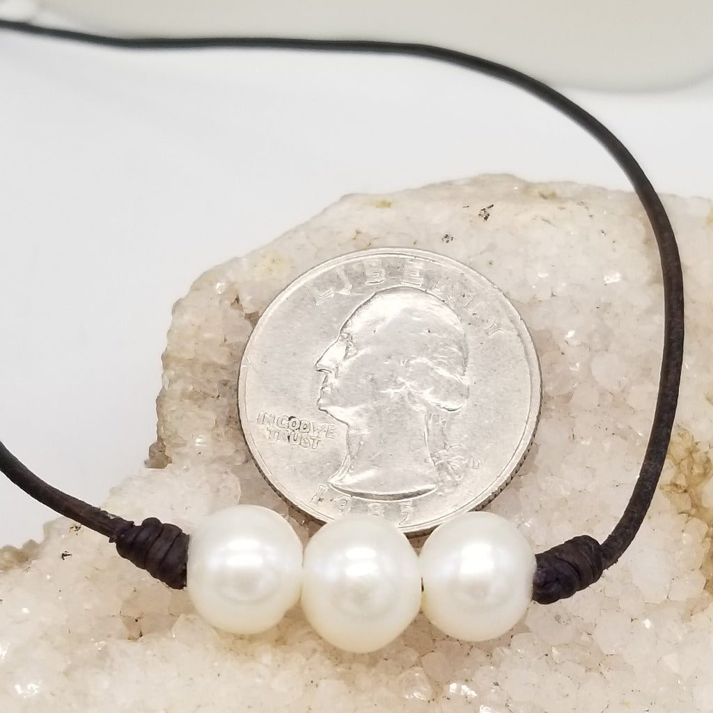 Three Freshwater Pearls on knotted leather with a sterling silver lobster claw clasp and a 1 in. extender chain