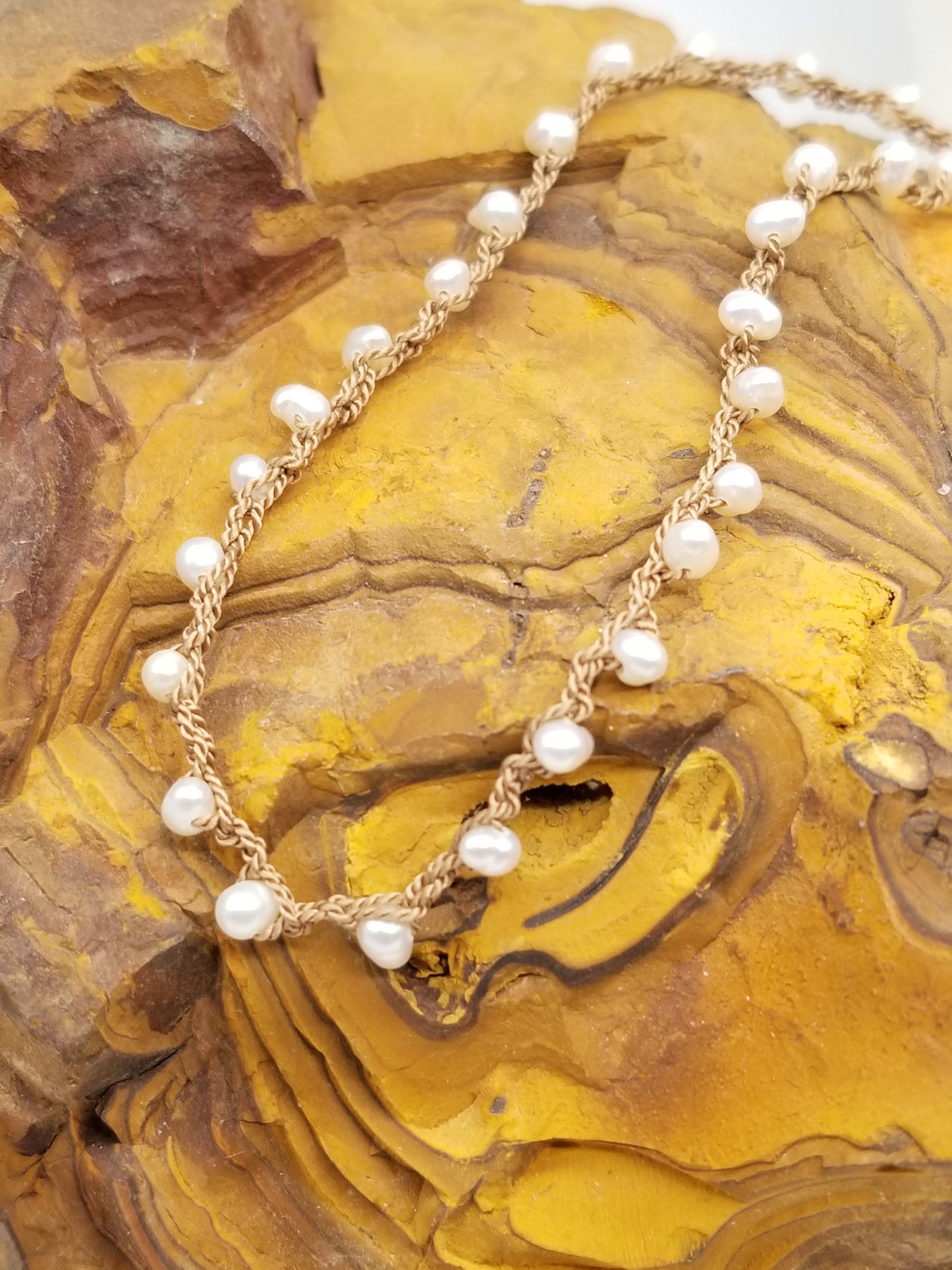 Fresh water pearls Hand Crocheted on a beige Silk