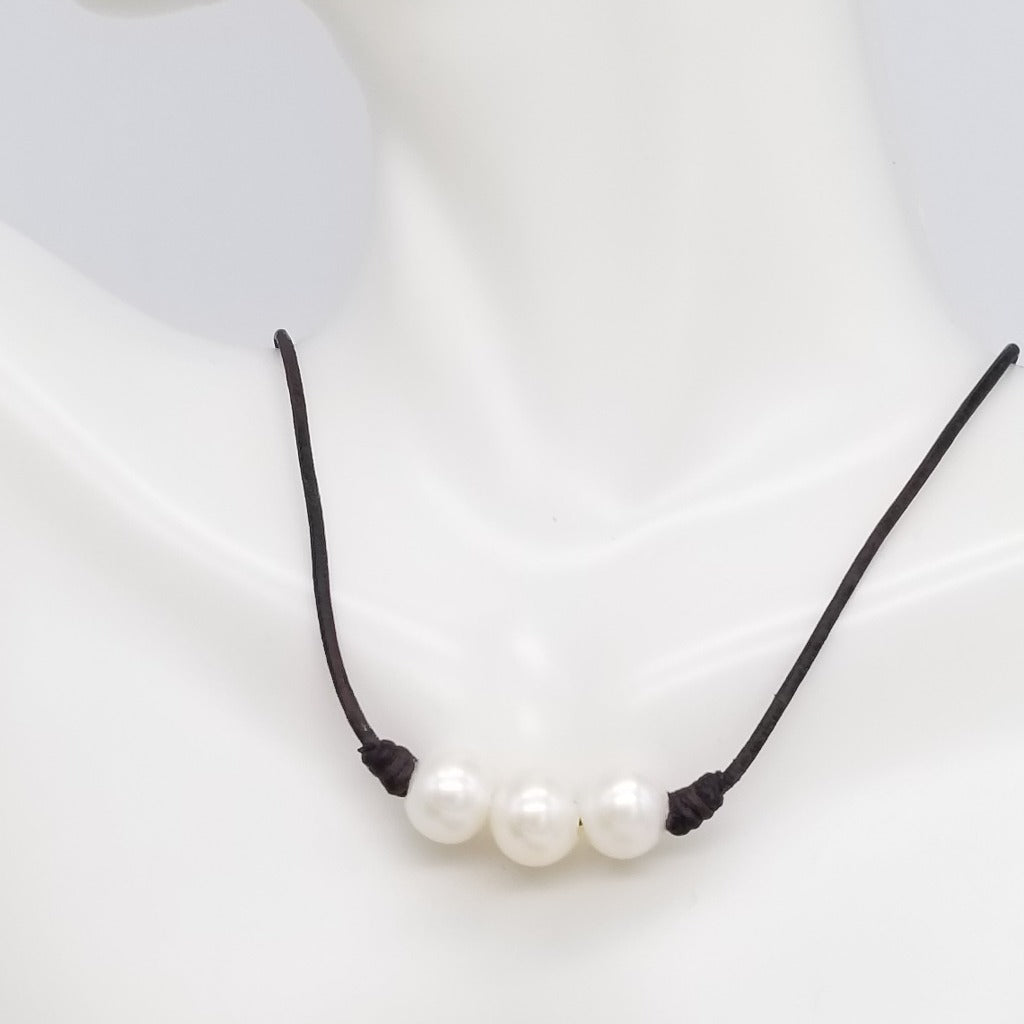 Three Freshwater Pearls on knotted leather with a sterling silver lobster claw clasp and a 1 in. extender chain