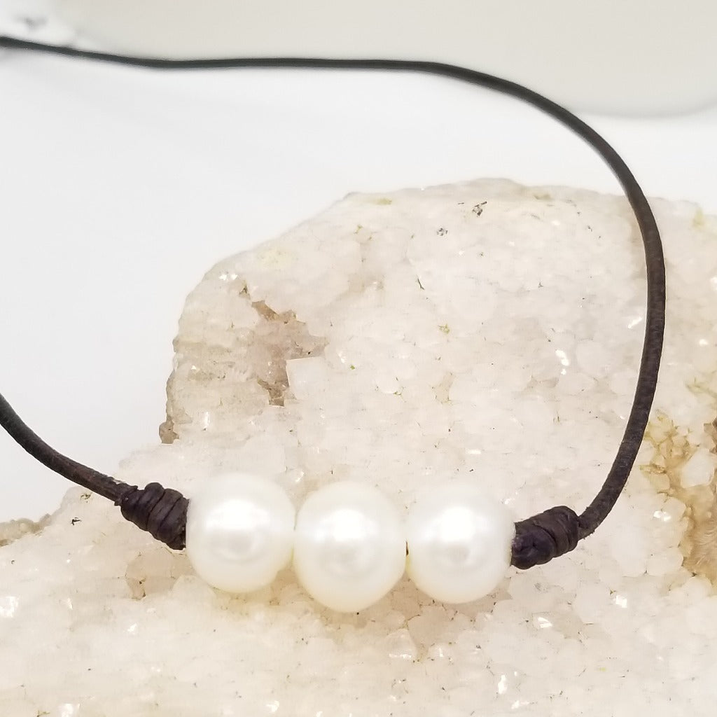 Three Freshwater Pearls on knotted leather with a sterling silver lobster claw clasp and a 1 in. extender chain